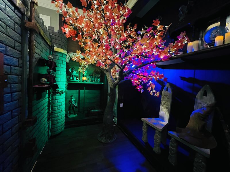 beautiful glowing tree inside a dark room with blue and green lights