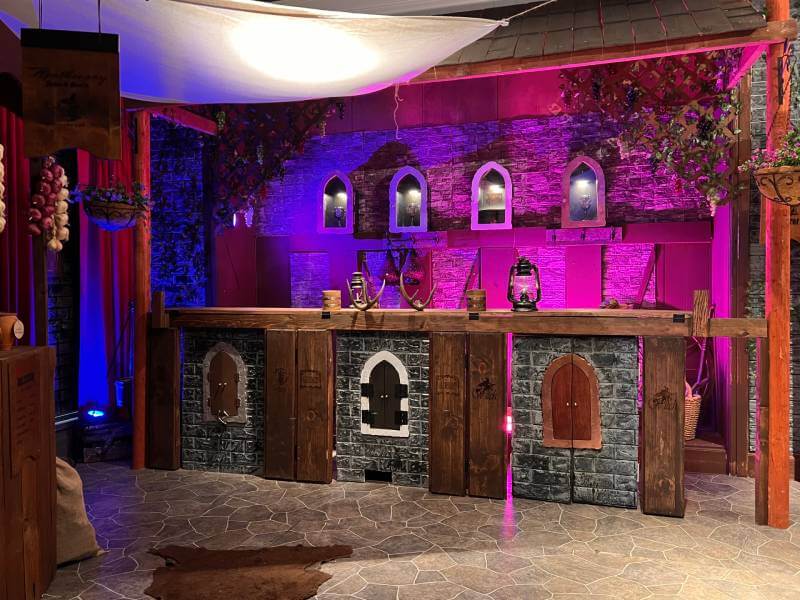 cool medieval wooden bar with pink lights in the background