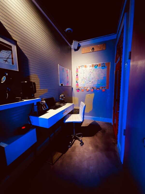 detectives rooms with blue lights and a map with pins in it